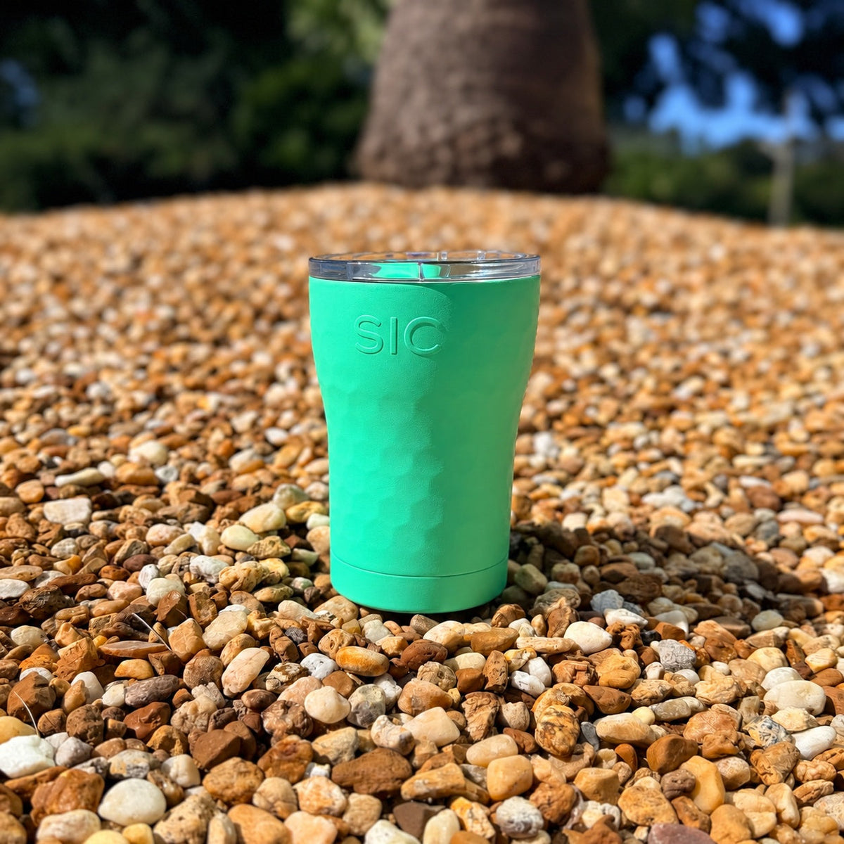 SIC Hammered Mint 12 oz. tumbler on pebbles