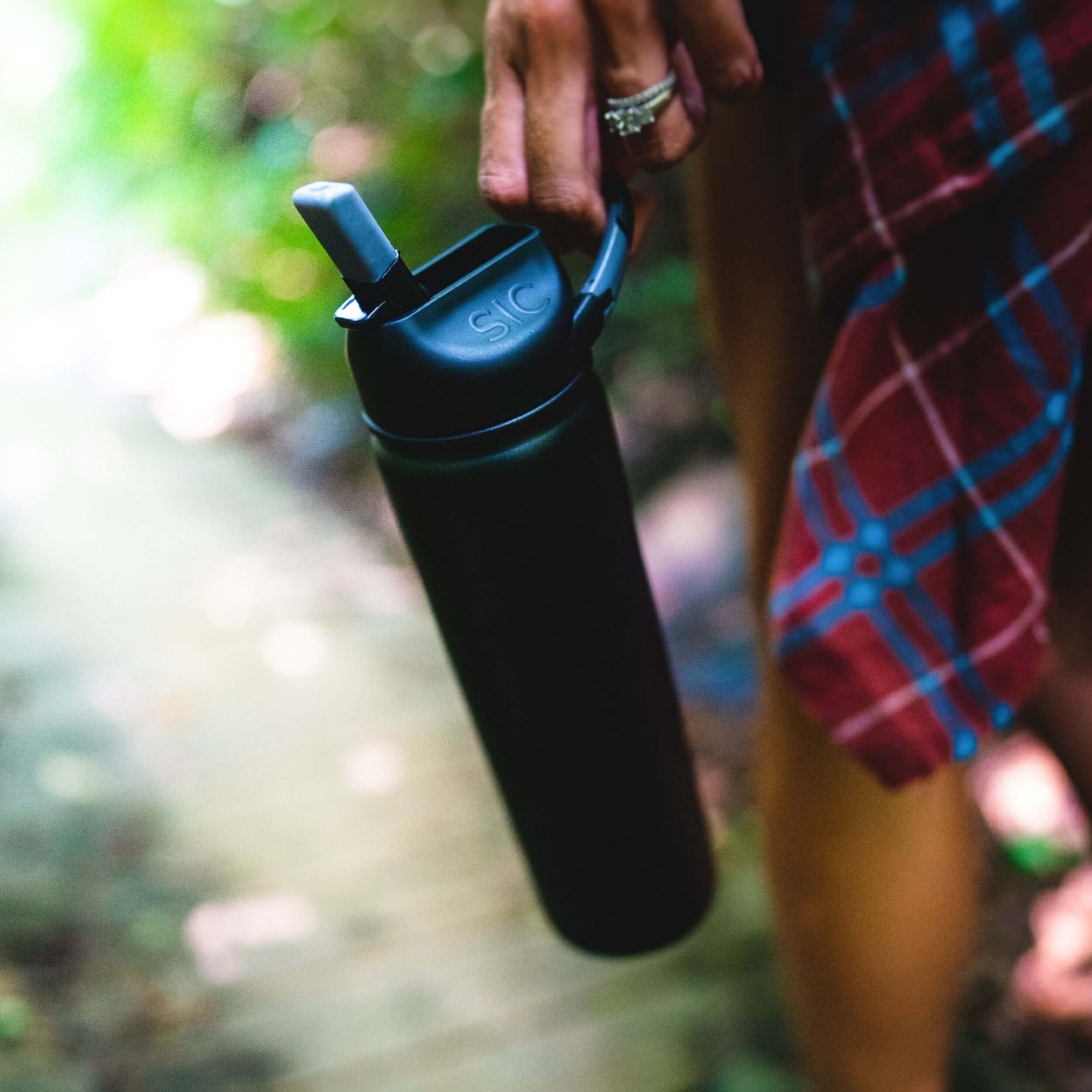 Matte Black 27 oz. Water Bottle on a Hiking Trail