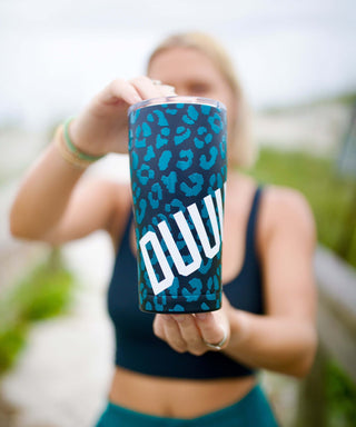Woman Holding Duuuval! Cup at the Beach