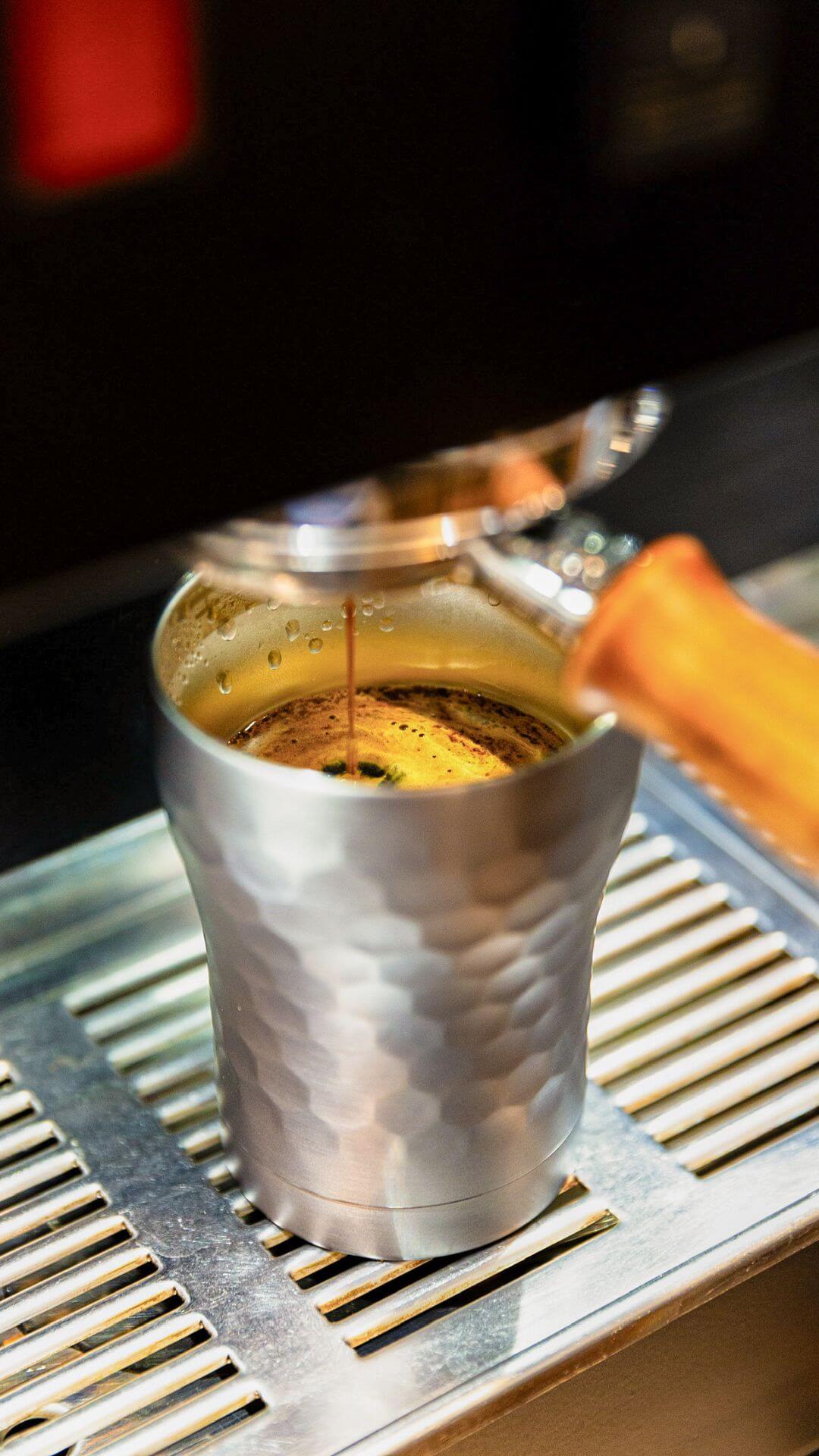 Hammered Gunmetal Tumbler filled with Coffee from Barista machine